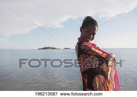 Woman wearing a sarong and smiling on the beach View Large Photo Image Stock Photo - Woman wearing a sarong and smiling on the beach. Fotosearch