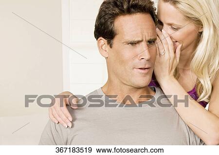 Woman whispering to a man View Large Photo Image Stock Photo - Woman whispering to a man. Fotosearch