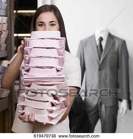 Stock Photo - Woman working in a clothing store. Fotosearch
