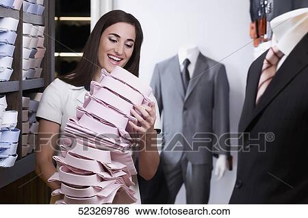 Woman working in a clothing store View Large Photo Image Stock Photograph - Woman working in a clothing store. Fotosearch