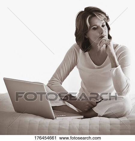 Woman working on a laptop View Large Photo Image Stock Image - Woman working on a laptop. Fotosearch