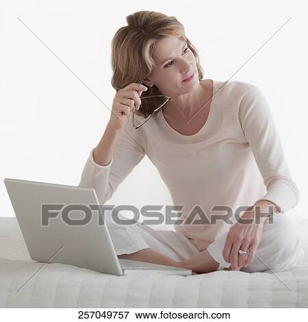 Woman working on a laptop View Large Photo Image Stock Photo - Woman working on a laptop. Fotosearch