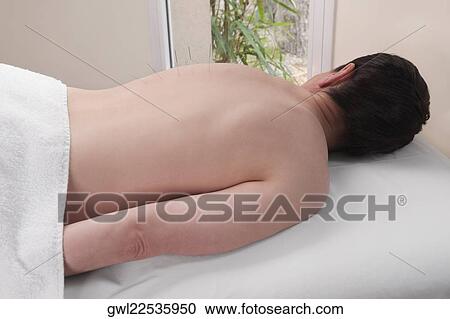 Stock Image - Acupuncture needles on a person's back. Fotosearch