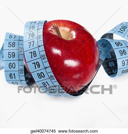 Stock Photography - Apple wrapped in a tape measure. Fotosearch