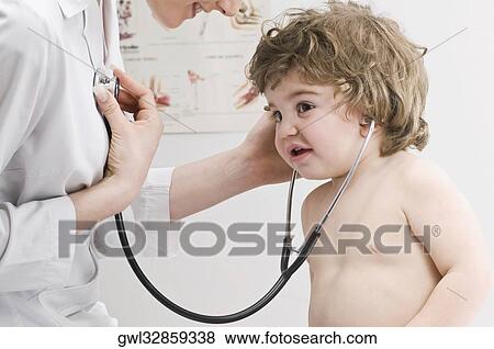 Baby boy listening to a doctor's heart beat View Large Photo Image Stock Photo - Baby boy listening to a doctor's heart beat. Fotosearch