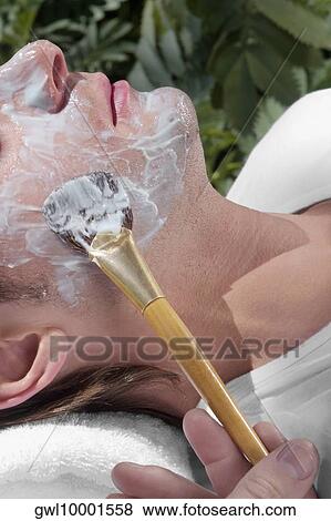 Beautician applying facial mask on a man's face View Large Photo Image Stock Photo - Beautician applying facial mask on a man's face. Fotosearch
