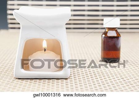 Bottle of aromatherapy oil and a burner View Large Photo Image Stock Photograph - Bottle of aromatherapy oil and a burner. Fotosearch