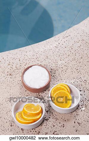 Bowls of orange slices and moisturizer cream at poolside View Large Photo Image Stock Image - Bowls of orange slices and moisturizer cream at poolside. Fotosearch