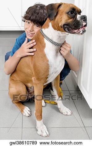 Stock Photo - Boy hugging a dog. Fotosearch