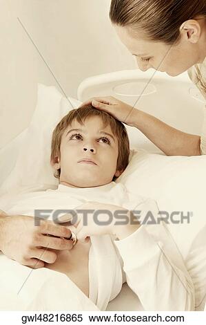 Stock Photography - Boy on a hospital bed with his mother. Fotosearch