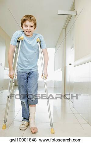 Boy standing with crutches and smiling View Large Photo Image Stock Photo - Boy standing with crutches and smiling. Fotosearch