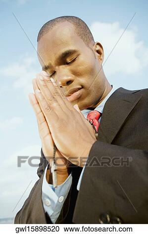 Businessman in prayer position View Large Photo Image Stock Image - Businessman in prayer position. Fotosearch