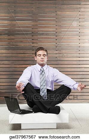 Businessman practicing yoga View Large Photo Image Stock Photo - Businessman practicing yoga. Fotosearch