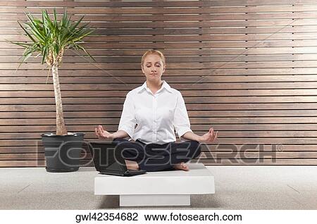 Businesswoman practicing yoga View Large Photo Image Stock Image - Businesswoman practicing yoga. Fotosearch
