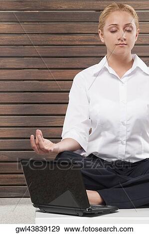 Businesswoman practicing yoga View Large Photo Image Stock Photo - Businesswoman practicing yoga. Fotosearch