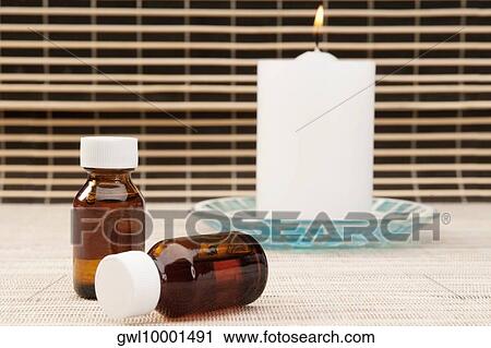 Candle with aromatherapy oil bottles View Large Photo Image Stock Image - Candle with aromatherapy oil bottles. Fotosearch