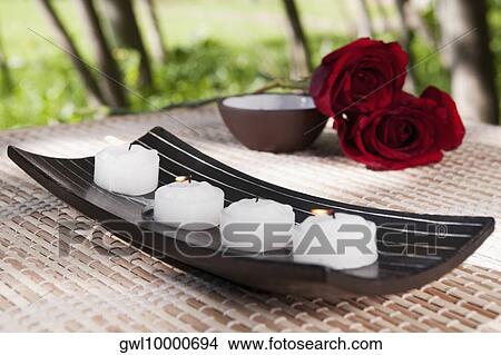 Picture - Candles on a tray with red roses. Fotosearch