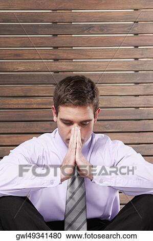 Close-up of a businessman practicing yoga View Large Photo Image Stock Image - Close-up of a businessman practicing yoga. Fotosearch
