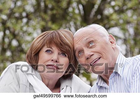 Stock Photograph - Close-up of a couple day dreaming. Fotosearch