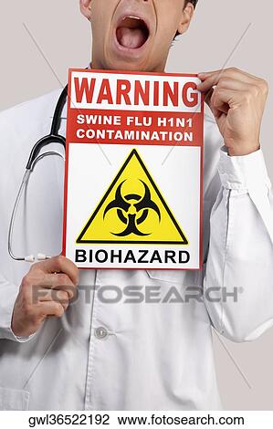 Close-up of a doctor showing a Biohazard warning sign View Large Photo Image Stock Image - Close-up of a doctor showing a Biohazard warning sign. Fotosearch
