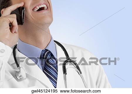 Close-up of a doctor talking on a mobile phone View Large Photo Image Stock Photography - Close-up of a doctor talking on a mobile phone. Fotosearch