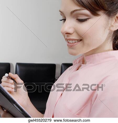 Stock Photo - Close-up of a female doctor holding a file. Fotosearch