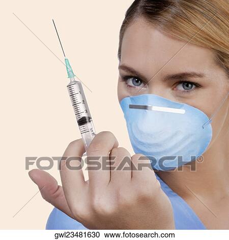 Close-up of a female nurse holding syringe View Large Photo Image Stock Image - Close-up of a female nurse holding syringe. Fotosearch
