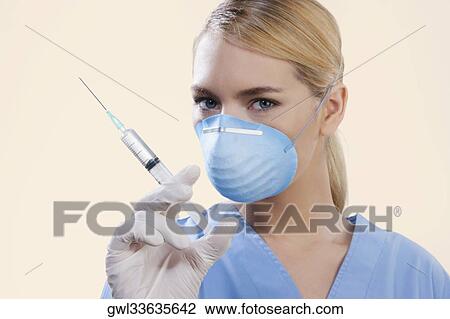 Close-up of a female nurse holding syringe View Large Photo Image Stock Image - Close-up of a female nurse holding syringe. Fotosearch