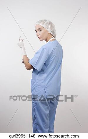 Close-up of a female surgeon wearing surgical gloves View Large Photo Image Stock Photo - Close-up of a female surgeon wearing surgical gloves. Fotosearch