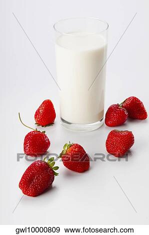 Close-up of a glass of milk and strawberries View Large Photo Image Stock Photo - Close-up of a glass of milk and strawberries. Fotosearch