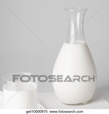Close-up of a jug and a glass of milk View Large Photo Image Stock Photography - Close-up of a jug and a glass of milk. Fotosearch