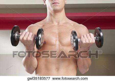 Close-up of a man exercising with dumbbells View Large Photo Image Stock Photo - Close-up of a man exercising with dumbbells. Fotosearch