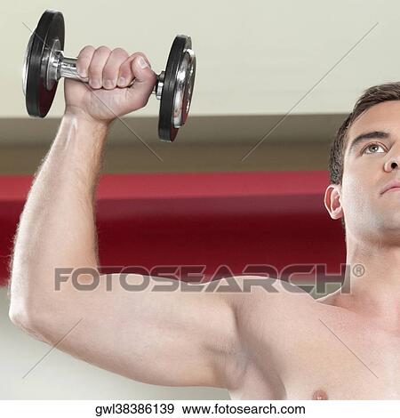 Close-up of a man exercising with dumbbells View Large Photo Image Stock Photo - Close-up of a man exercising with dumbbells. Fotosearch