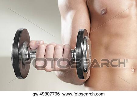 Close-up of a man exercising with dumbbells View Large Photo Image Stock Photograph - Close-up of a man exercising with dumbbells. Fotosearch