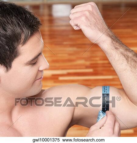 Close-up of a man measuring his biceps with a tape measure View Large Photo Image Stock Photography - Close-up of a man measuring his biceps with a tape measure. Fotosearch