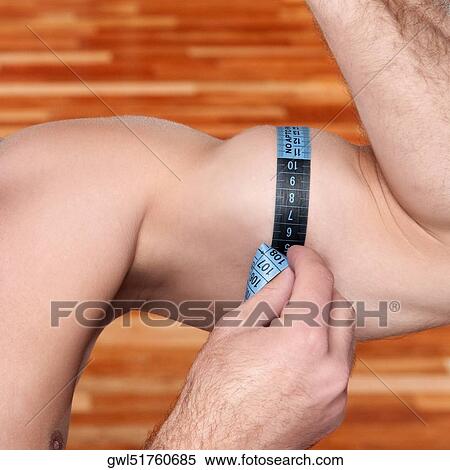 Close-up of a man measuring his biceps with a tape measure View Large Photo Image Stock Photography - Close-up of a man measuring his biceps with a tape measure. Fotosearch