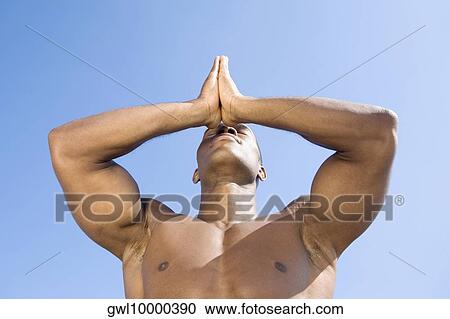 Stock Image - Close-up of a man meditating. Fotosearch