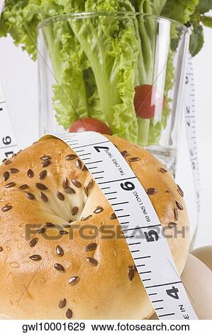 Close-up of a tape measure on a bagel with vegetables View Large Photo Image Stock Photo - Close-up of a tape measure on a bagel with vegetables. Fotosearch