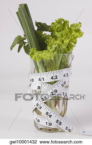 Close-up of a tape measure wrapped around a glass full of vegetables View Large Photo Image Stock Image - Close-up of a tape measure wrapped around a glass full of vegetables. Fotosearch