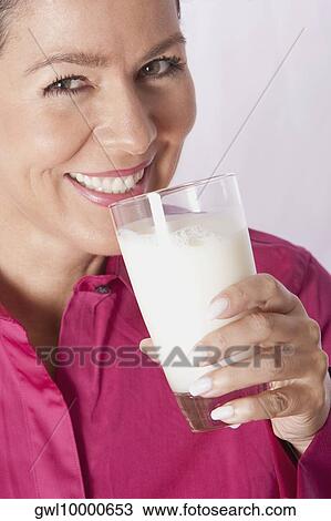 Close-up of a woman drinking milk from a glass View Large Photo Image Stock Image - Close-up of a woman drinking milk from a glass. Fotosearch