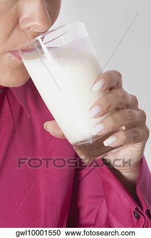 Close-up of a woman drinking milk from a glass View Large Photo Image Stock Image - Close-up of a woman drinking milk from a glass. Fotosearch