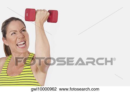 Close-up of a woman exercising with a dumbbell View Large Photo Image Stock Image - Close-up of a woman exercising with a dumbbell. Fotosearch