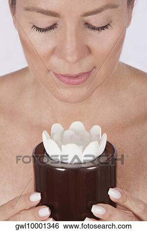 Close-up of a woman holding a candle View Large Photo Image Stock Photograph - Close-up of a woman holding a candle. Fotosearch