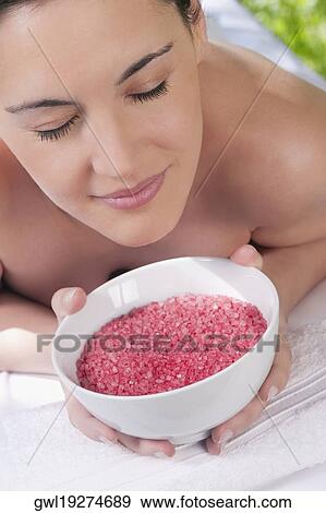 Close-up of a woman lying on a massage table and smelling a bowl of bath salt View Large Photo Image Stock Photo - Close-up of a woman lying on a massage table and smelling a bowl of bath salt. Fotosearch