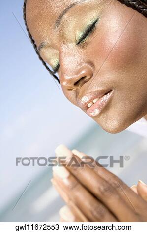 Close-up of a woman meditating View Large Photo Image Stock Image - Close-up of a woman meditating. Fotosearch