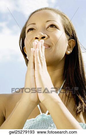 Close-up of a woman meditating View Large Photo Image Stock Image - Close-up of a woman meditating. Fotosearch