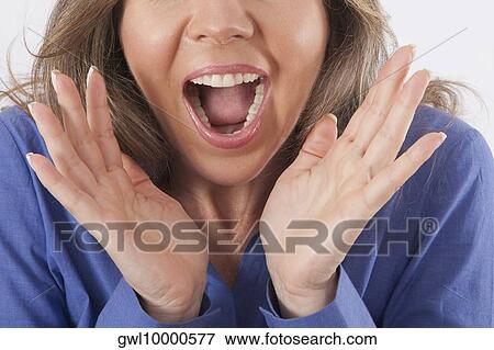 Close-up of a woman shouting View Large Photo Image Stock Photo - Close-up of a woman shouting. Fotosearch