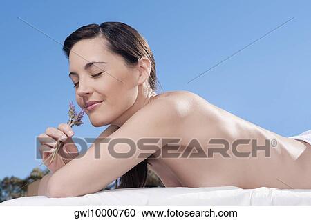 Close-up of a woman smelling lavender flowers View Large Photo Image Stock Image - Close-up of a woman smelling lavender flowers. Fotosearch