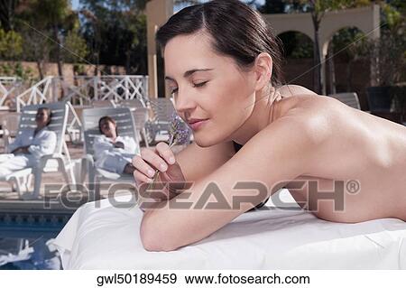 Stock Photo - Close-up of a woman smelling lavender flowers. Fotosearch