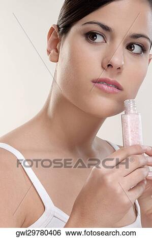Close-up of a woman smelling moisturizer cream View Large Photo Image Stock Photograph - Close-up of a woman smelling moisturizer cream. Fotosearch